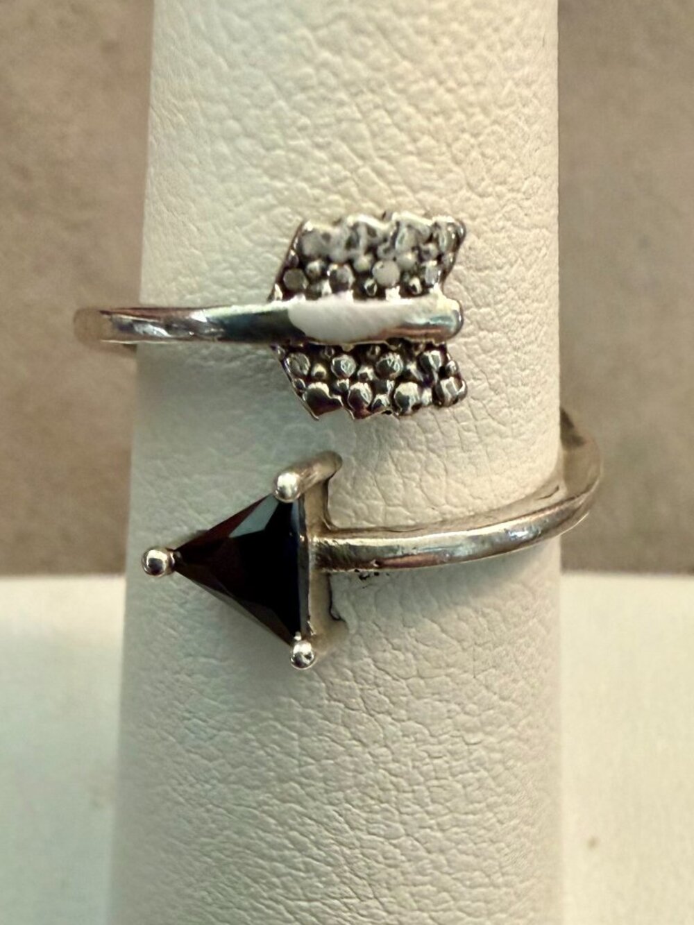 Arrow wrap ring crafted from sterling silver with a simulated black onyx stone.